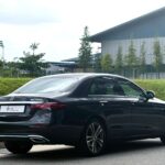 Rear view of Mercedes-Benz E200 showing 9G-TRONIC badging and sleek LED taillights.