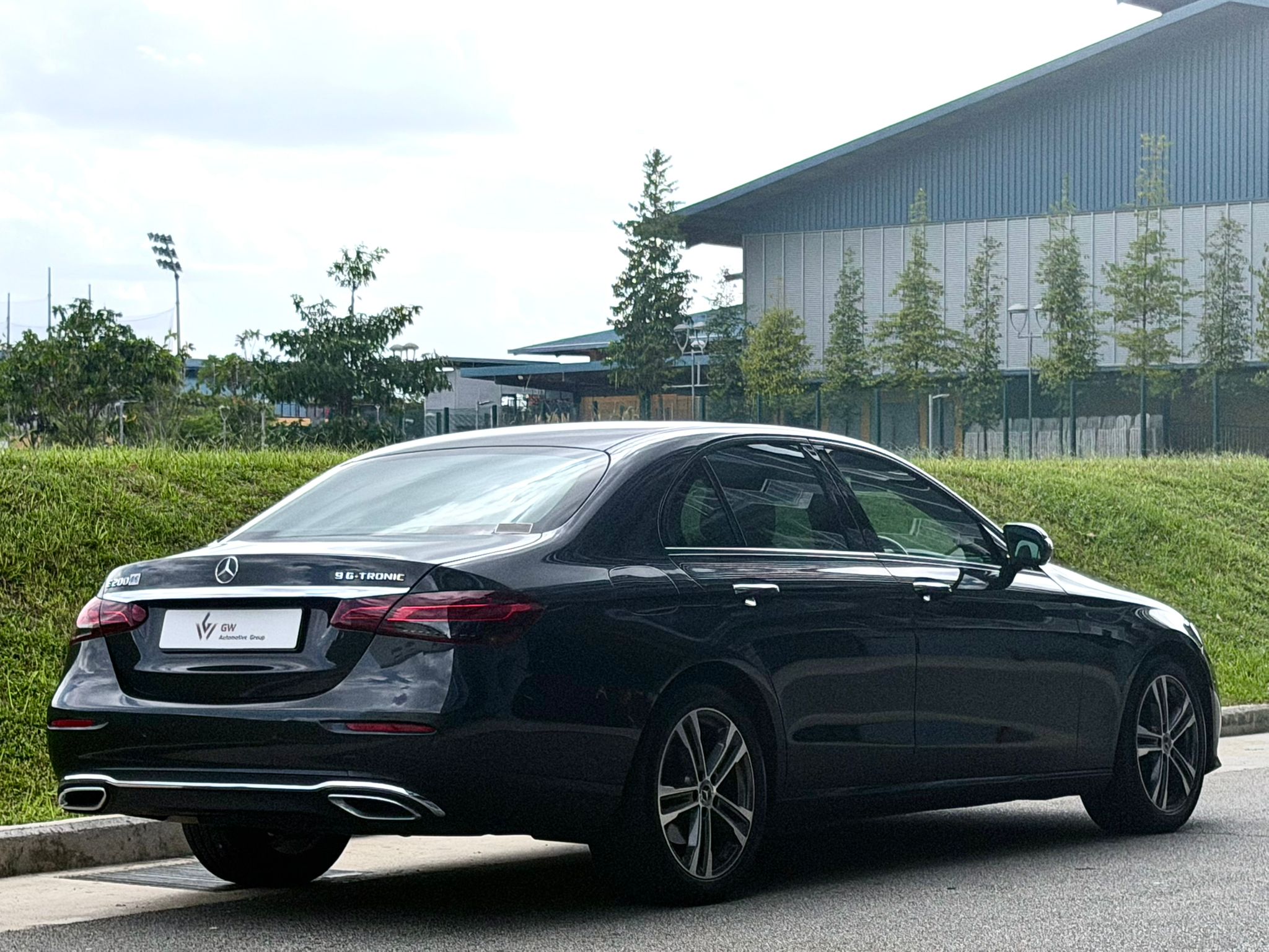 Rear view of Mercedes-Benz E200 showing 9G-TRONIC badging and sleek LED taillights.