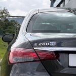 Close-up of Mercedes-Benz E200 badge and chrome detailing on trunk.
