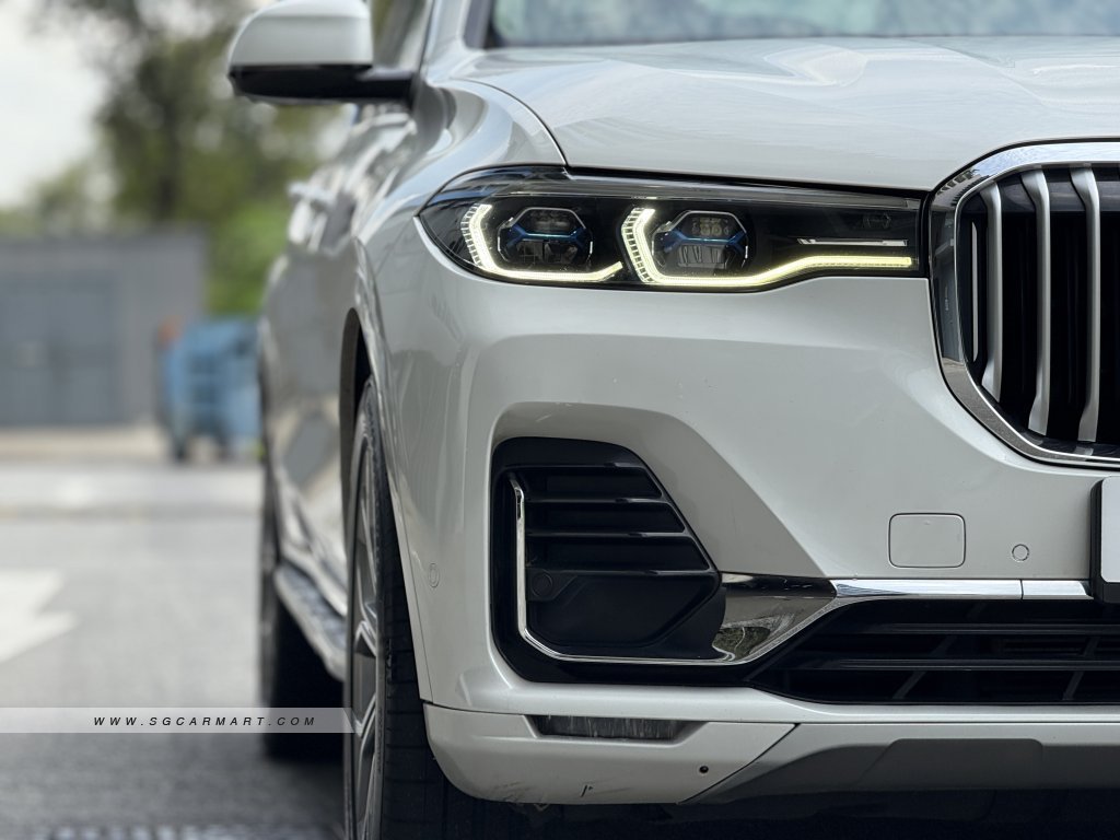 Close-up of BMW X7 LED headlights and signature kidney grille on a white Pure Excellence model.