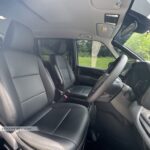 Premium black leather upholstery in the front cabin of a 7-seater Toyota Noah Hybrid.